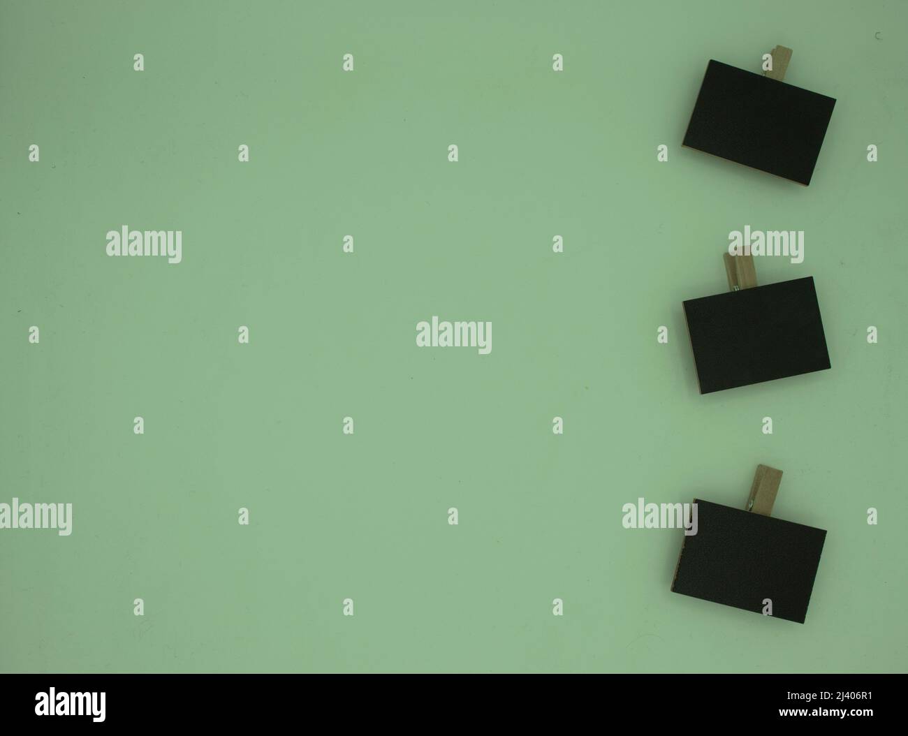 Green background with three small peg blackboards Stock Photo