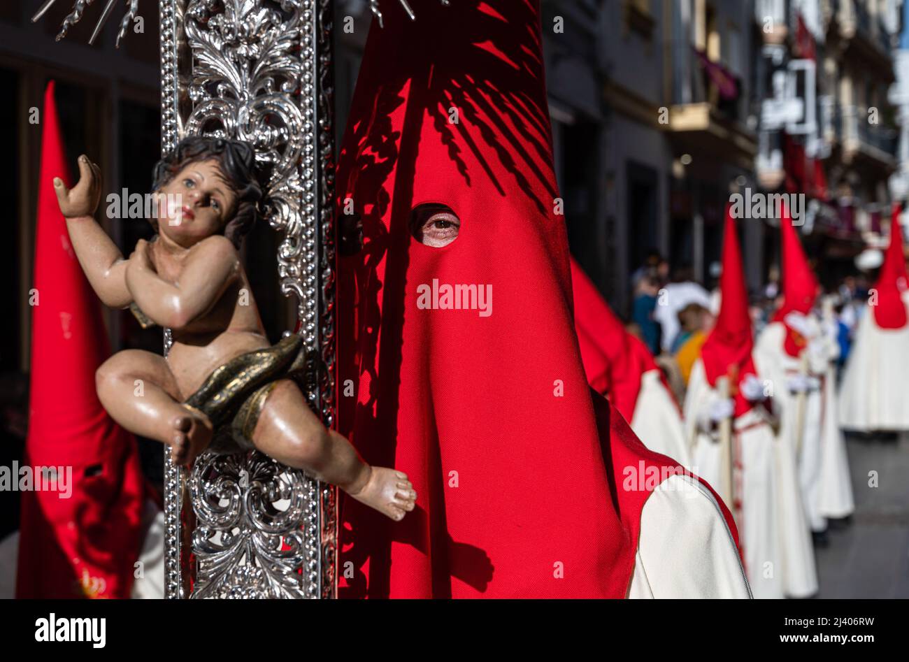 Penitents are seen during a procession to celebrate Palm Sunday, also