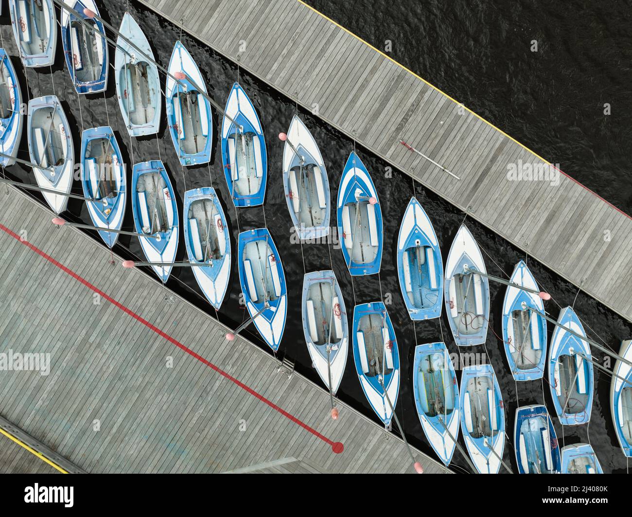Rows of blue and white sailboats docked near the Charles river in Boston aerial view Stock Photo