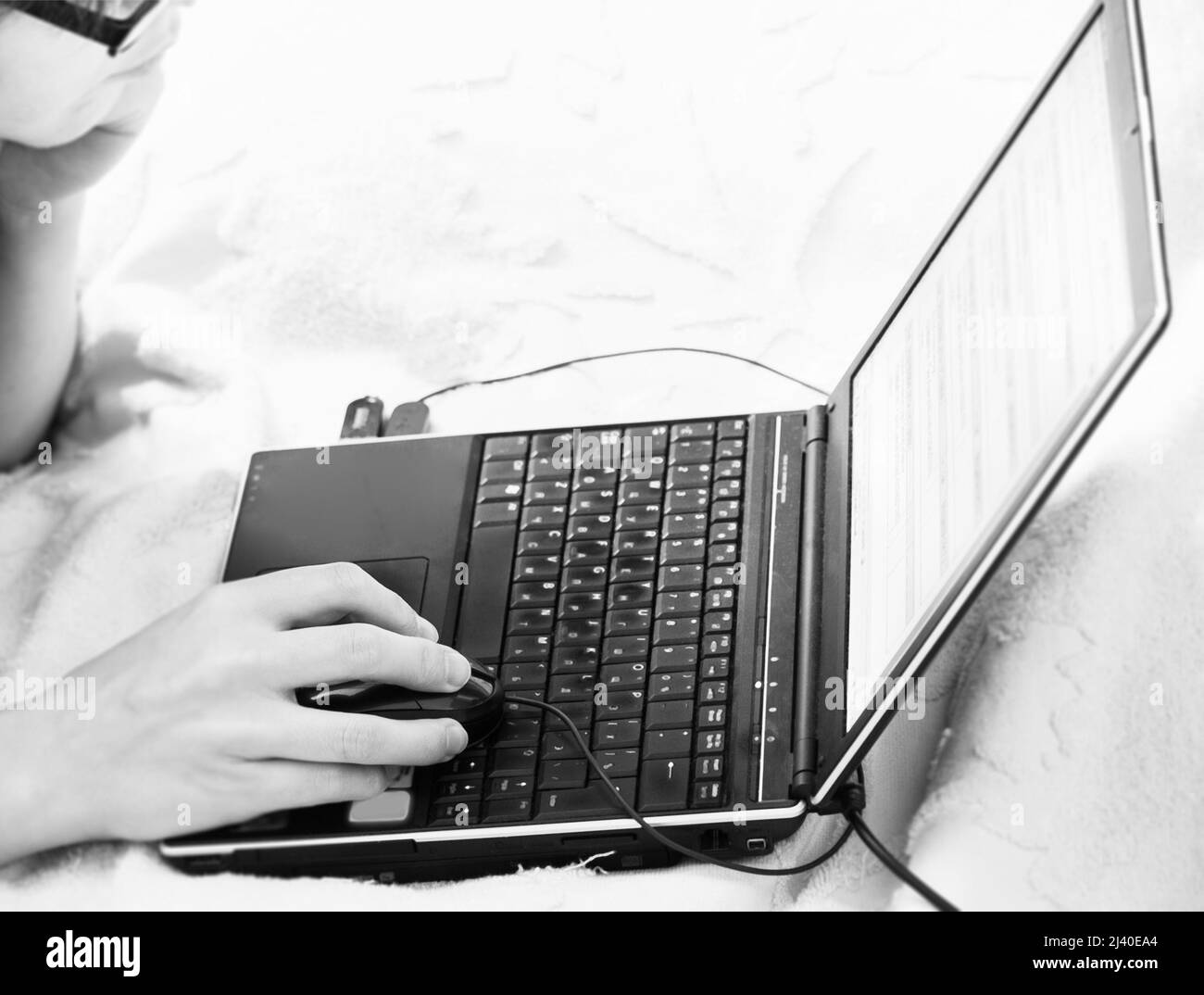 woman with laptop on bed Stock Photo