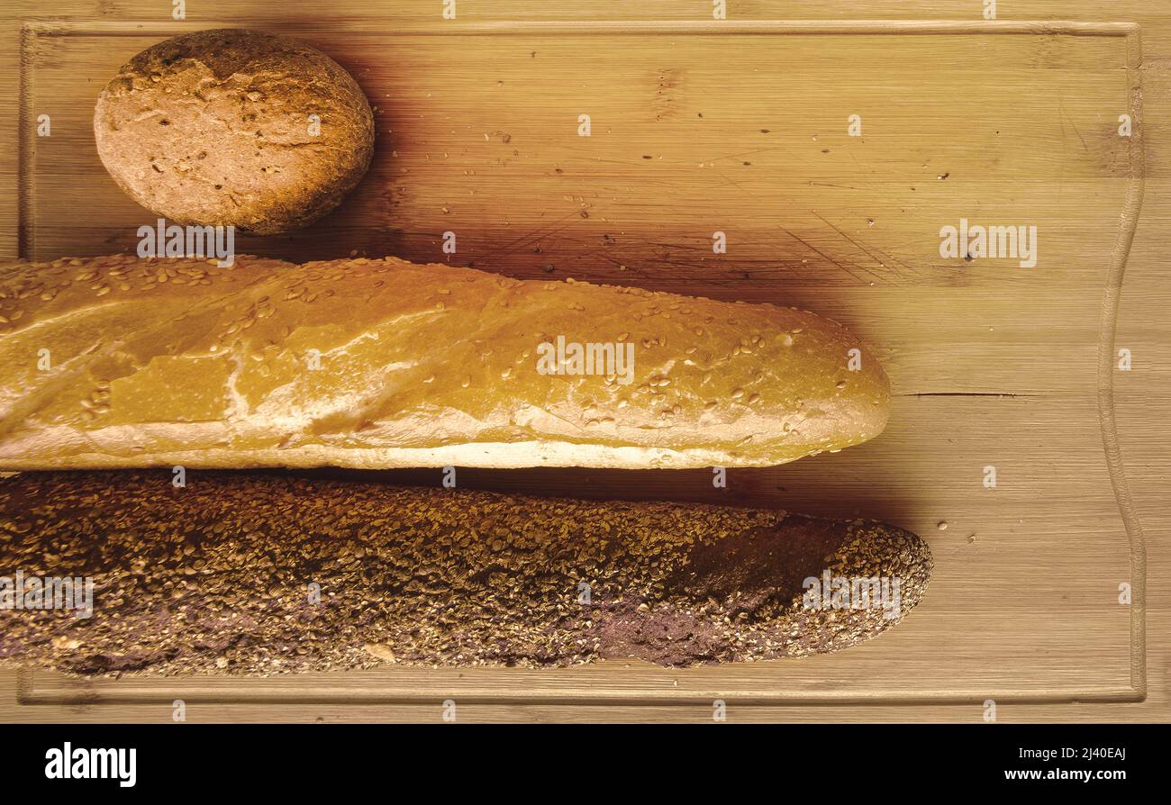 white and black breads on breadboard Stock Photo