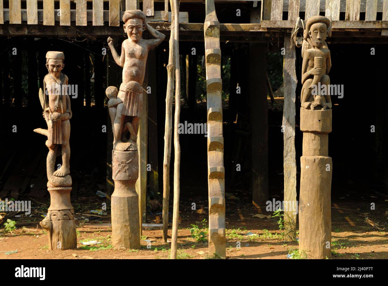 Various effigies flank the steps into this Dayak longhouse in the remote village of Eheng. Stock Photo