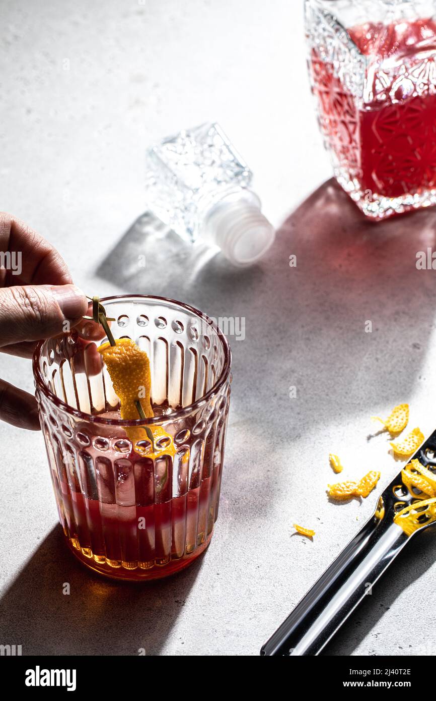 Human hand making red short drink over concrete table background Stock Photo Alamy