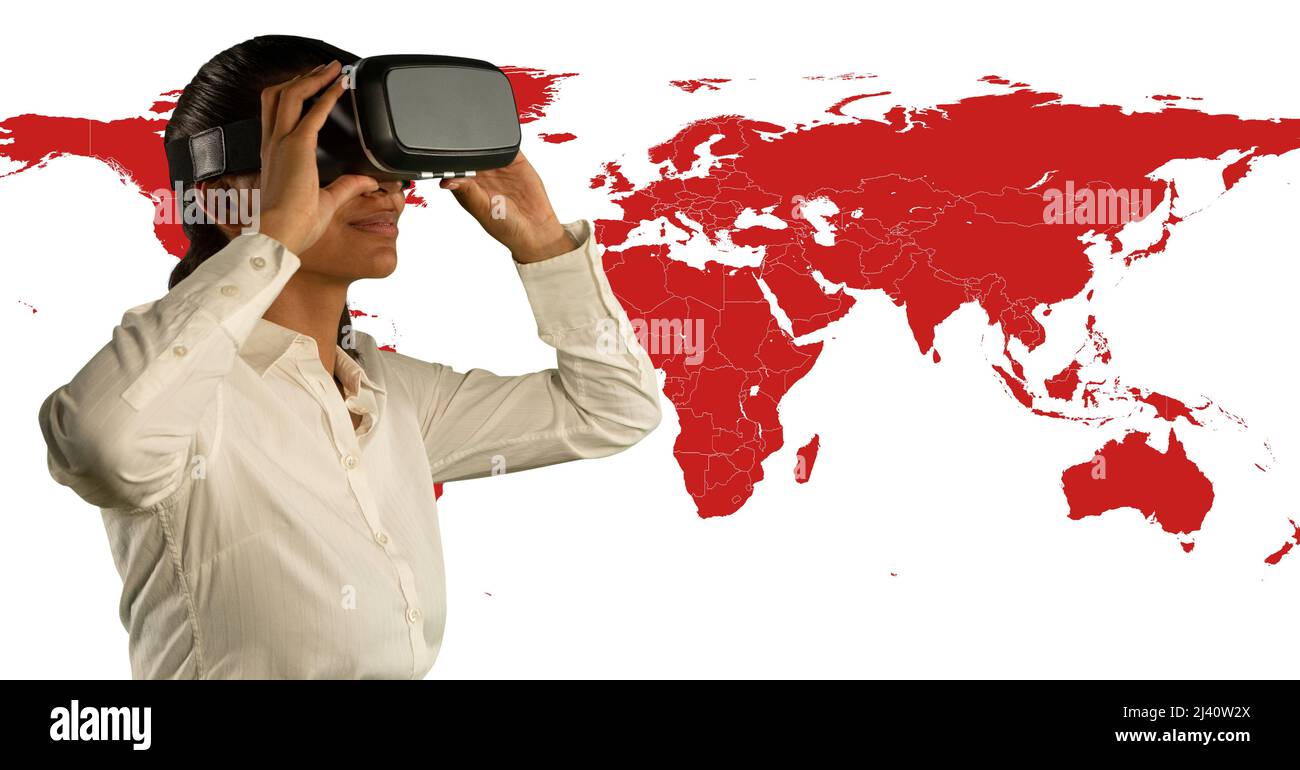 African american woman wearing vr headset against world map on white background Stock Photo