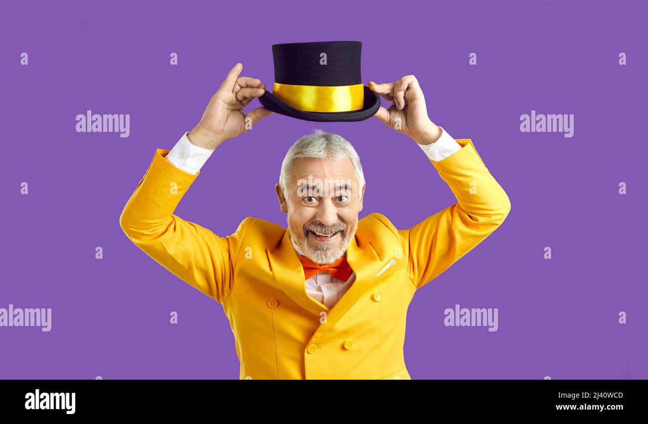 Funny elderly man entertain audience make tricks Stock Photo
