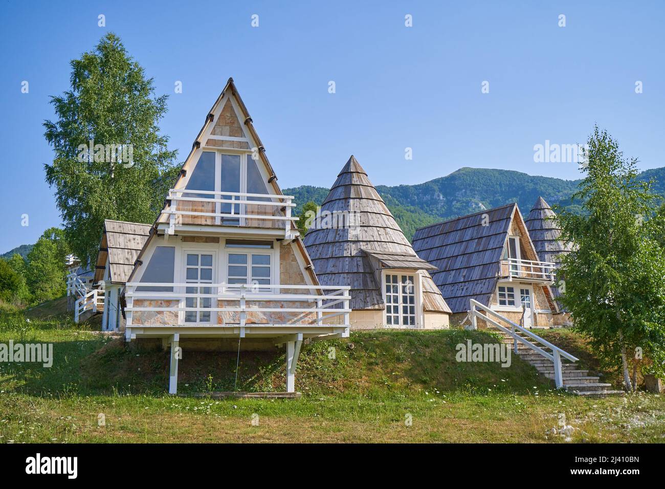 Lovely peaked roof bungalow houses for hikers in the mountains Stock Photo