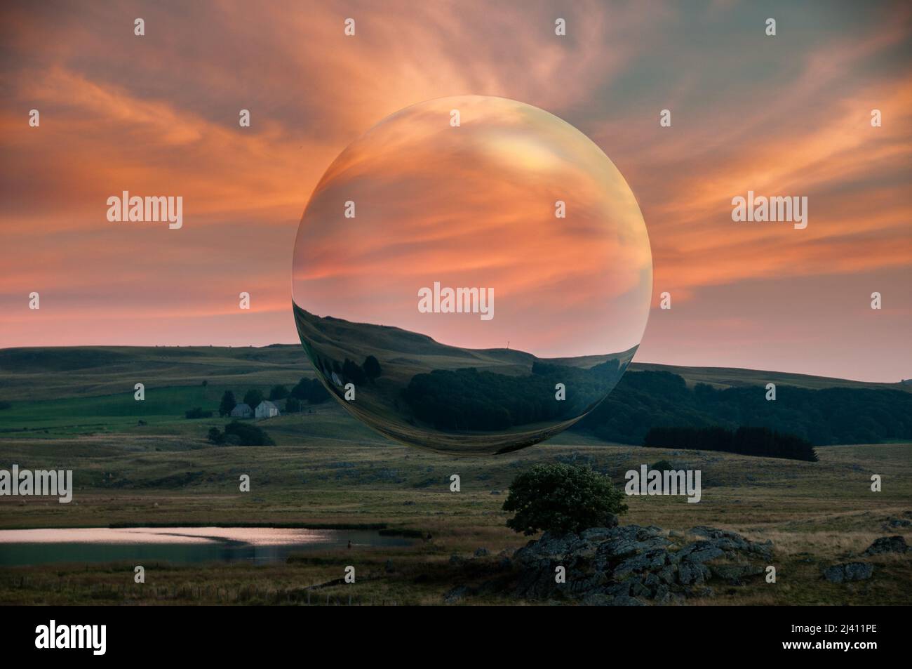 surreal sphere floating in the middle of a beautiful landscape ...