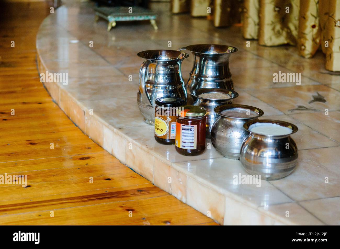 28th February 2010.  Inis Rath, Fermanagh, Northern Ireland.  Silver bowls containing milk, along with honey and ghee sit on the alter in a Hare Krishna Temple in advance of the Abhisheka Ceremony Stock Photo