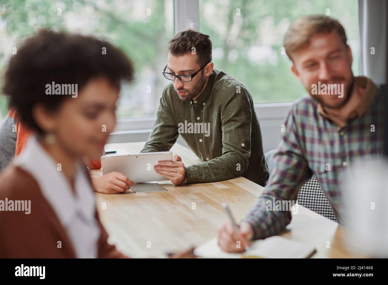 multinational business team using a laptop at a work meeting Stock ...