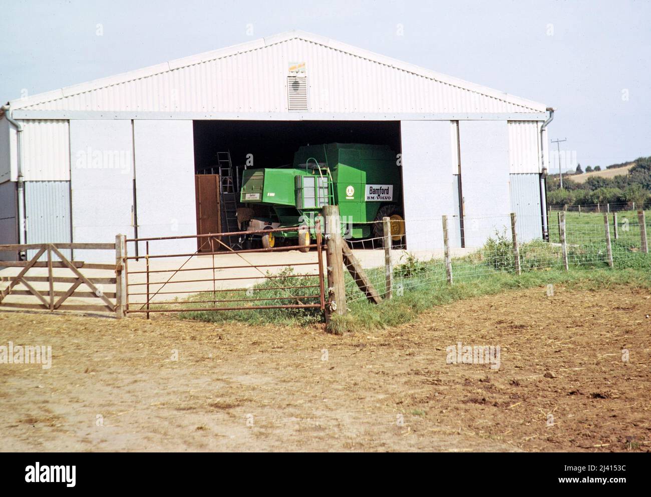 Bamford BM Volvo S900 combine harvester in farm barn, unspecified location, England, UK 1972 Stock Photo