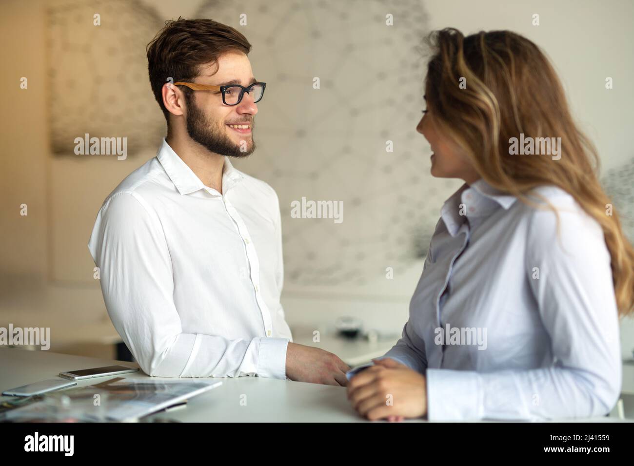 Two young colleagues chatting together on a break Stock Photo