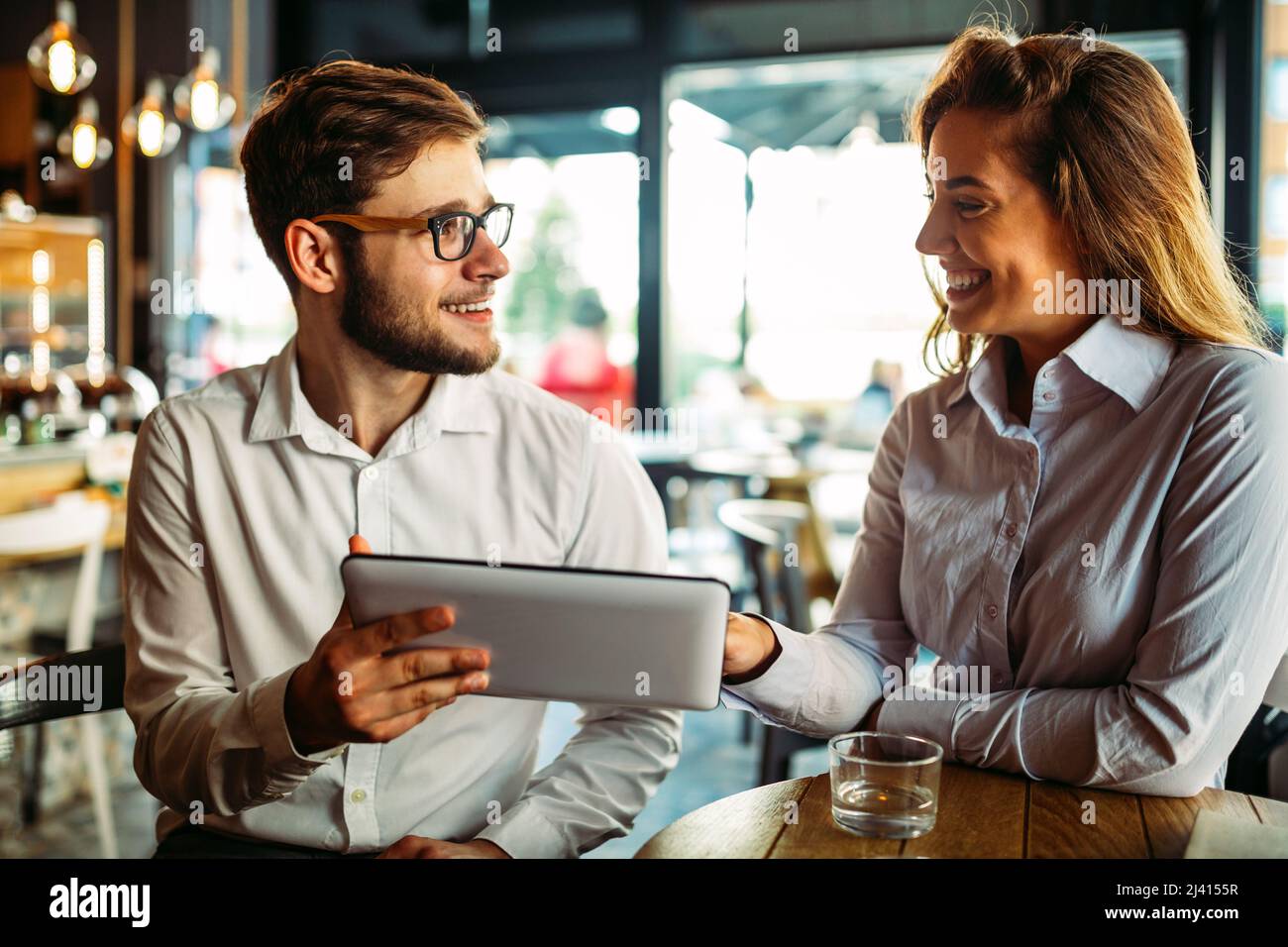 Two young colleagues chatting together on a break Stock Photo