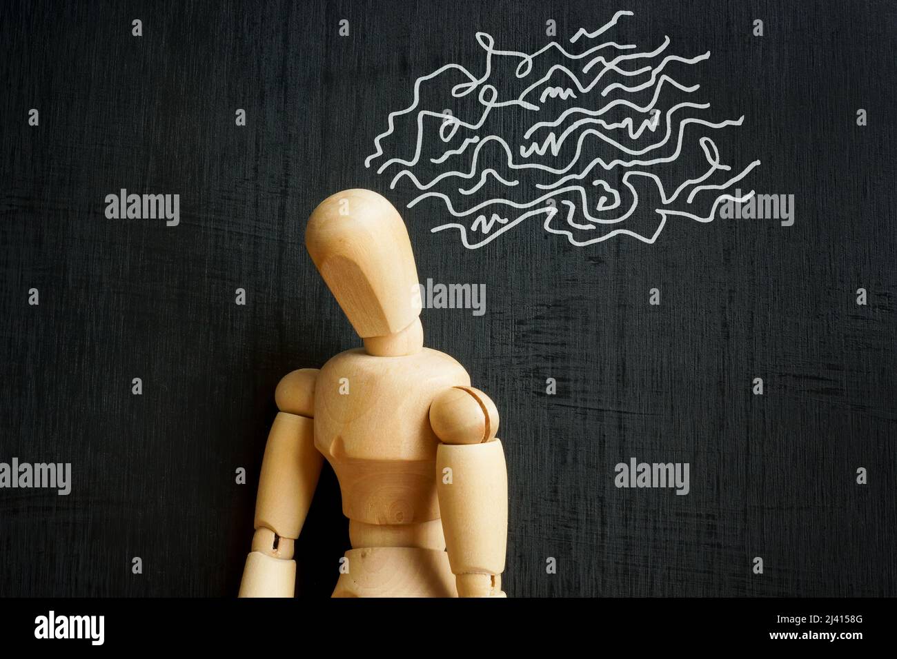 Depression and negative thoughts concept. Wooden figurine and drawn lines. Stock Photo
