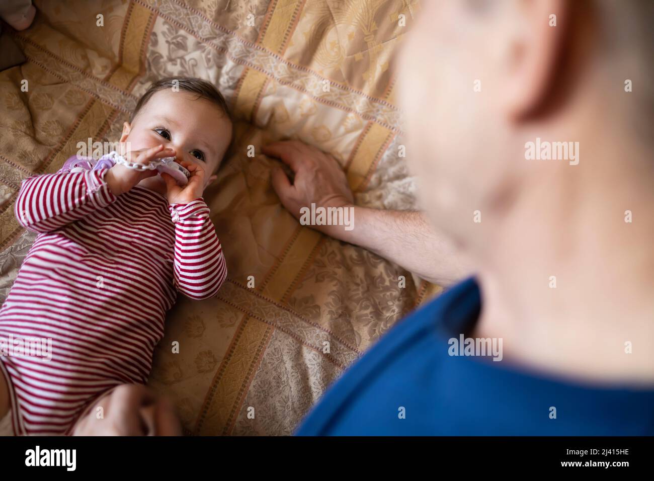 Small baby playing with her grandpa Stock Photo