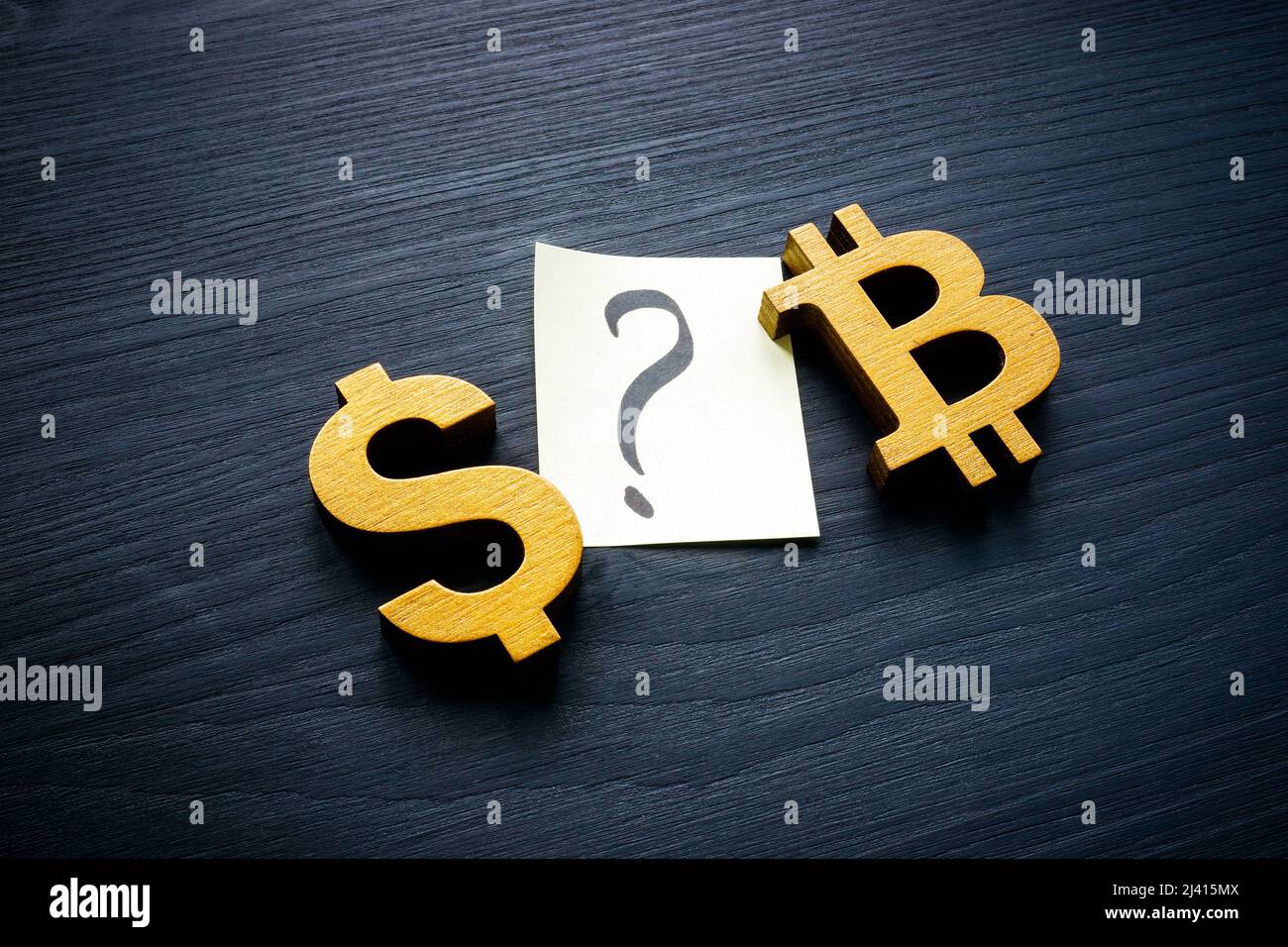 Dollar and Bitcoin signs and question mark as buy or sell concept. Stock Photo