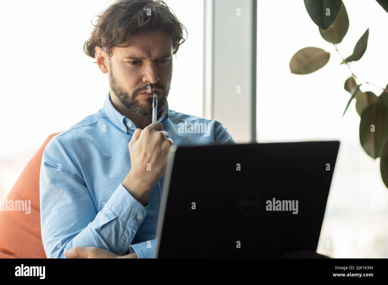 Focused business man using laptop at office Stock Photo