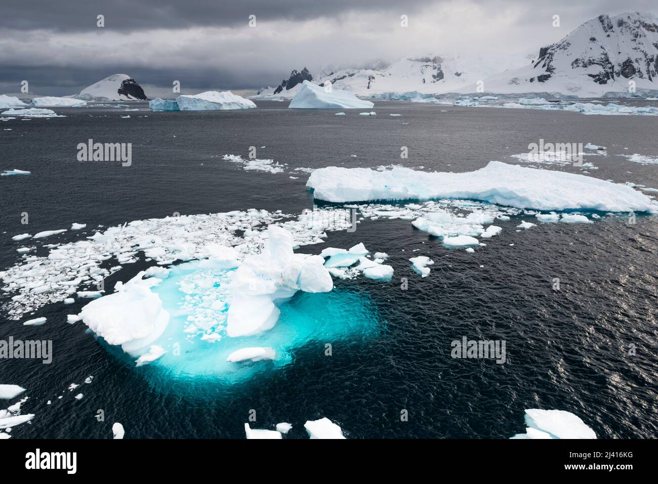 Looking west from Danco Island, Errera Channel,  towards the islands bounding the Gerlache Strait, with icebergs, islands and drift ice.  Antarctica Stock Photo