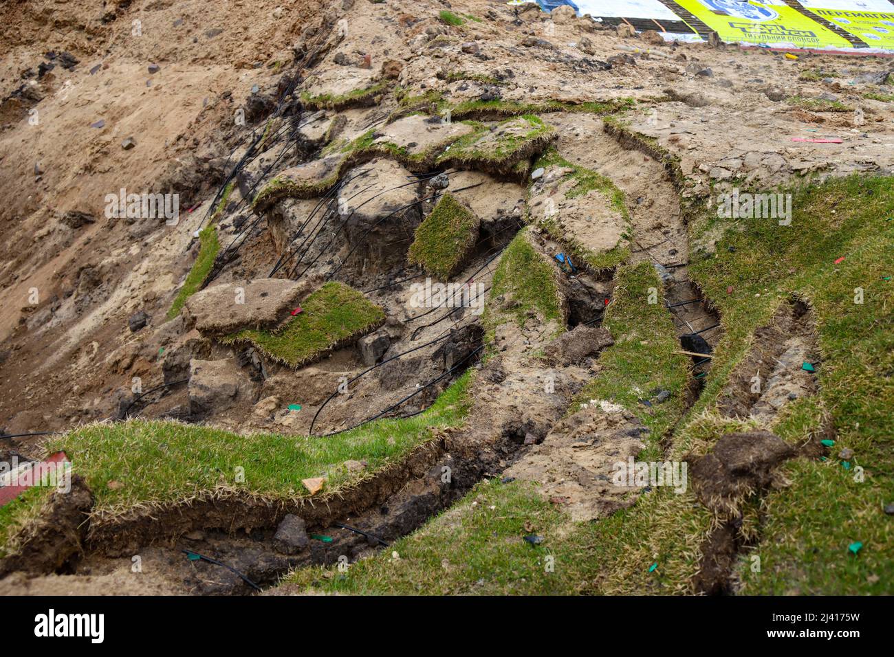 CHERNIHIV, UKRAINE - APRIL 9, 2022 - The damaged turf is seen by the edge of a crater at the Chernihiv Olympic Sports Training Centre (formerly Yuri G Stock Photo