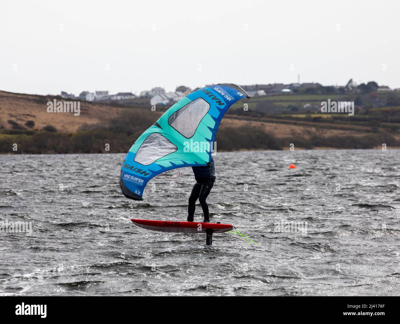 People wind foiling on Stithians Lake, Menherion in South West Cornwall