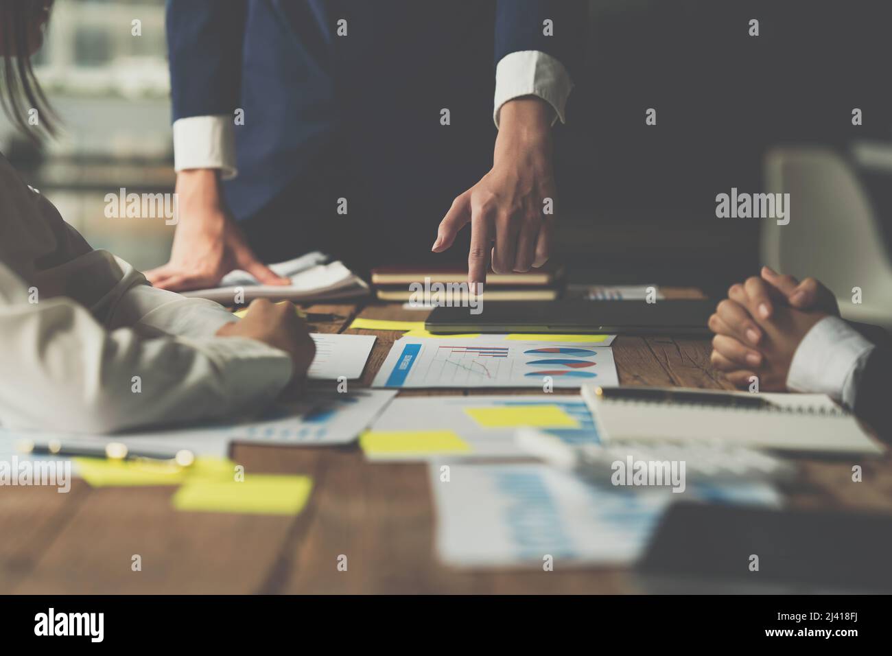 Group of Businesswoman and Accountant checking data document on digital tablet for investigation of corruption account . Anti Bribery concept. Stock Photo