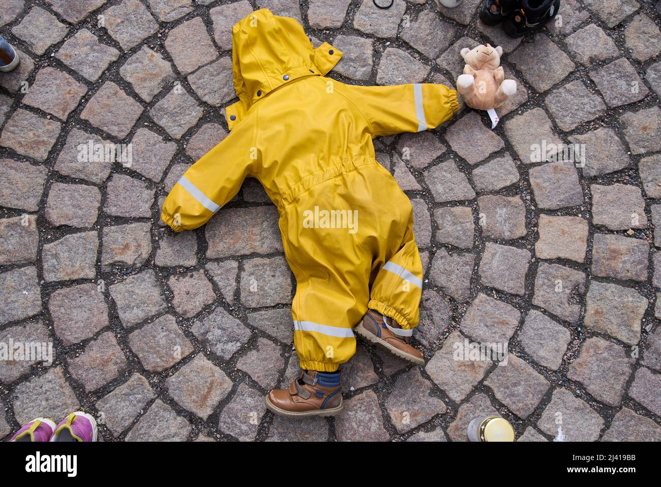 Helsinki, Finland - April 10, 2022: Twisted yellow children’s overalls and shoes in the event “Mariupol: russian war crimes” organised by the Ukrainia Stock Photo