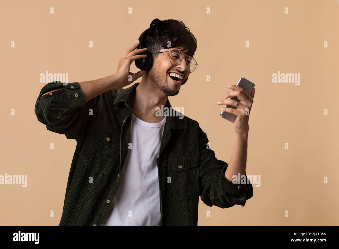 Happy hindu man enjoying newest stereo headset Stock Photo - Alamy