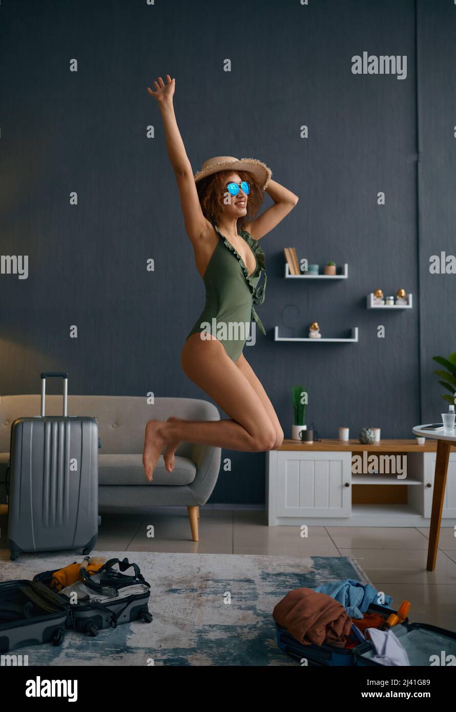 Woman in swimsuit represent herself on beach Stock Photo