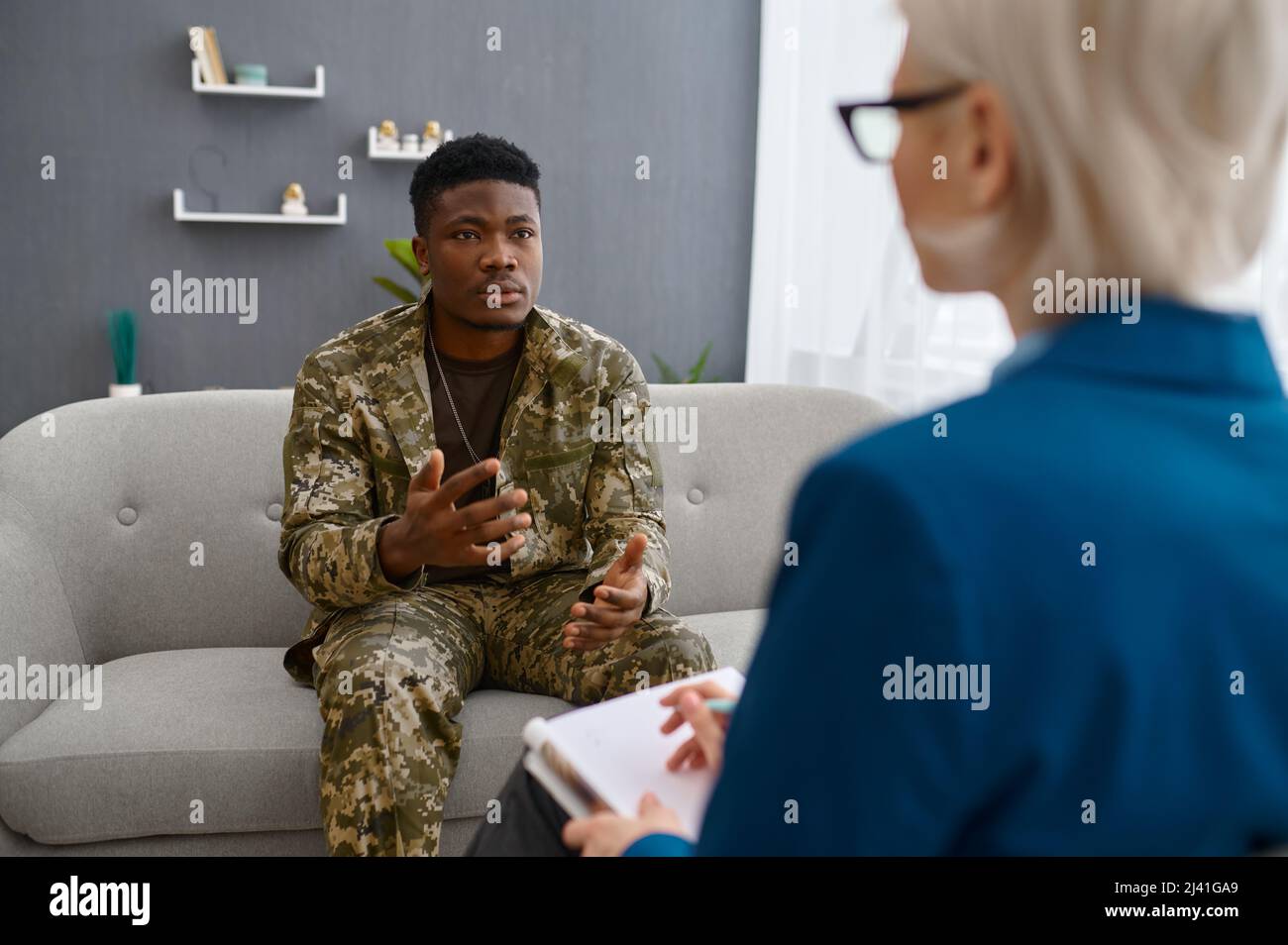 Professional psychologist giving advice to military patient Stock Photo