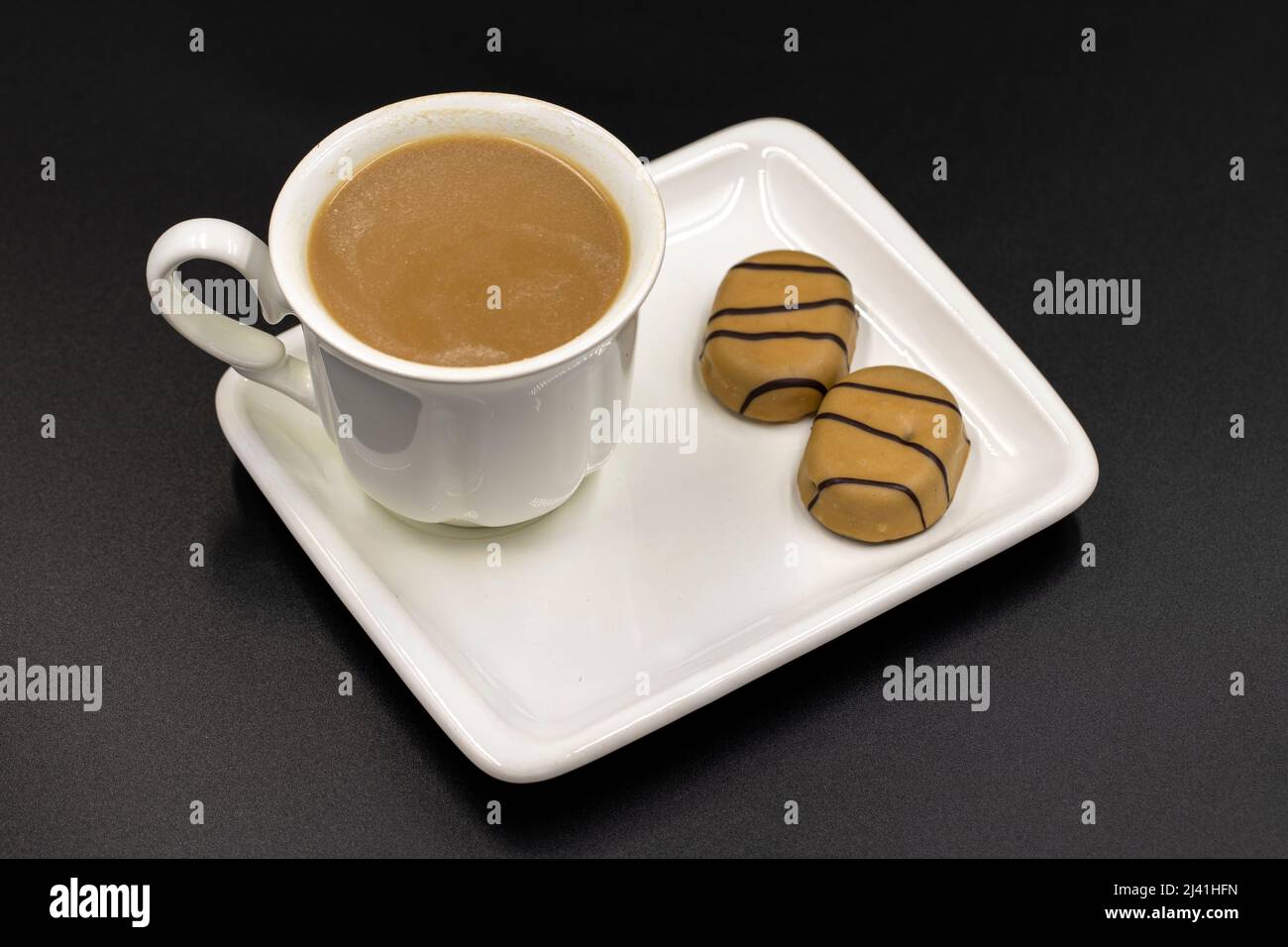 Cup of coffee and chocolate on black background. morning coffee Stock Photo