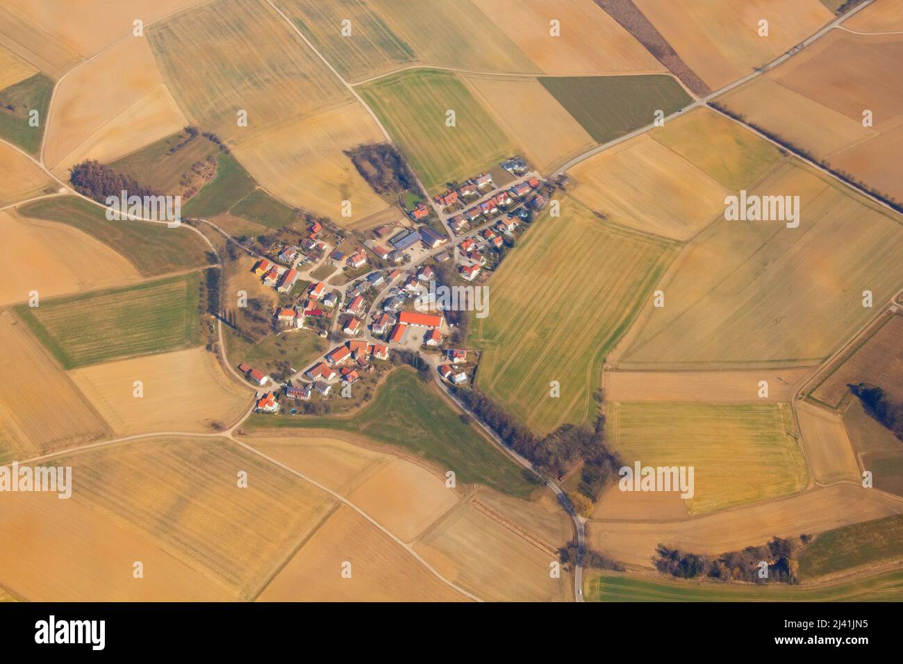 Aerial picture of rural German Bavarian village surrounded by golden