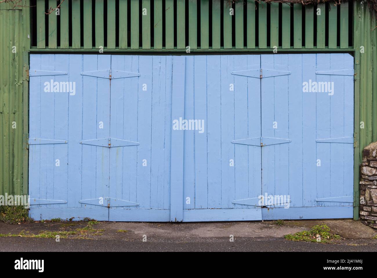 Old blue wooden painted garage doors. Stock Photo