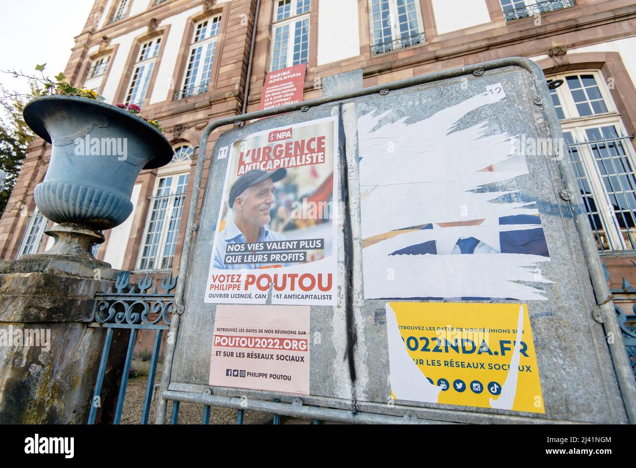 STRASBOURG, FRANCE - APR 23, 2022: French presidential posters for the upcoming presidential election in France, in front of the City Hall building in Strasbourg featuring Philippe Poutou and Nicolas Dupont-Aignan Stock Photo