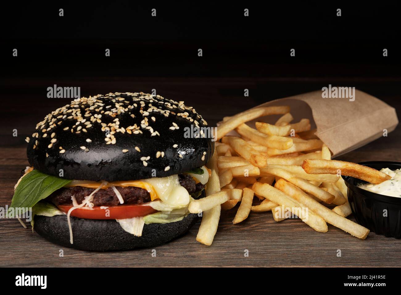 black burger on chalkboard with french fries Stock Photo Alamy