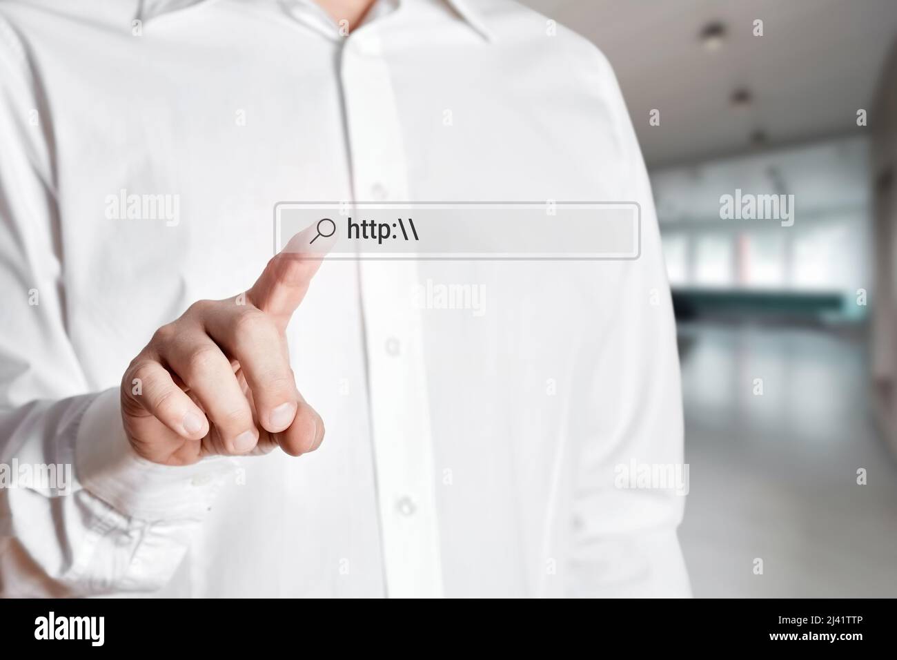 Businessman press the search icon on the internet search bar on a virtual screen with the word http. Internet search concept. Stock Photo
