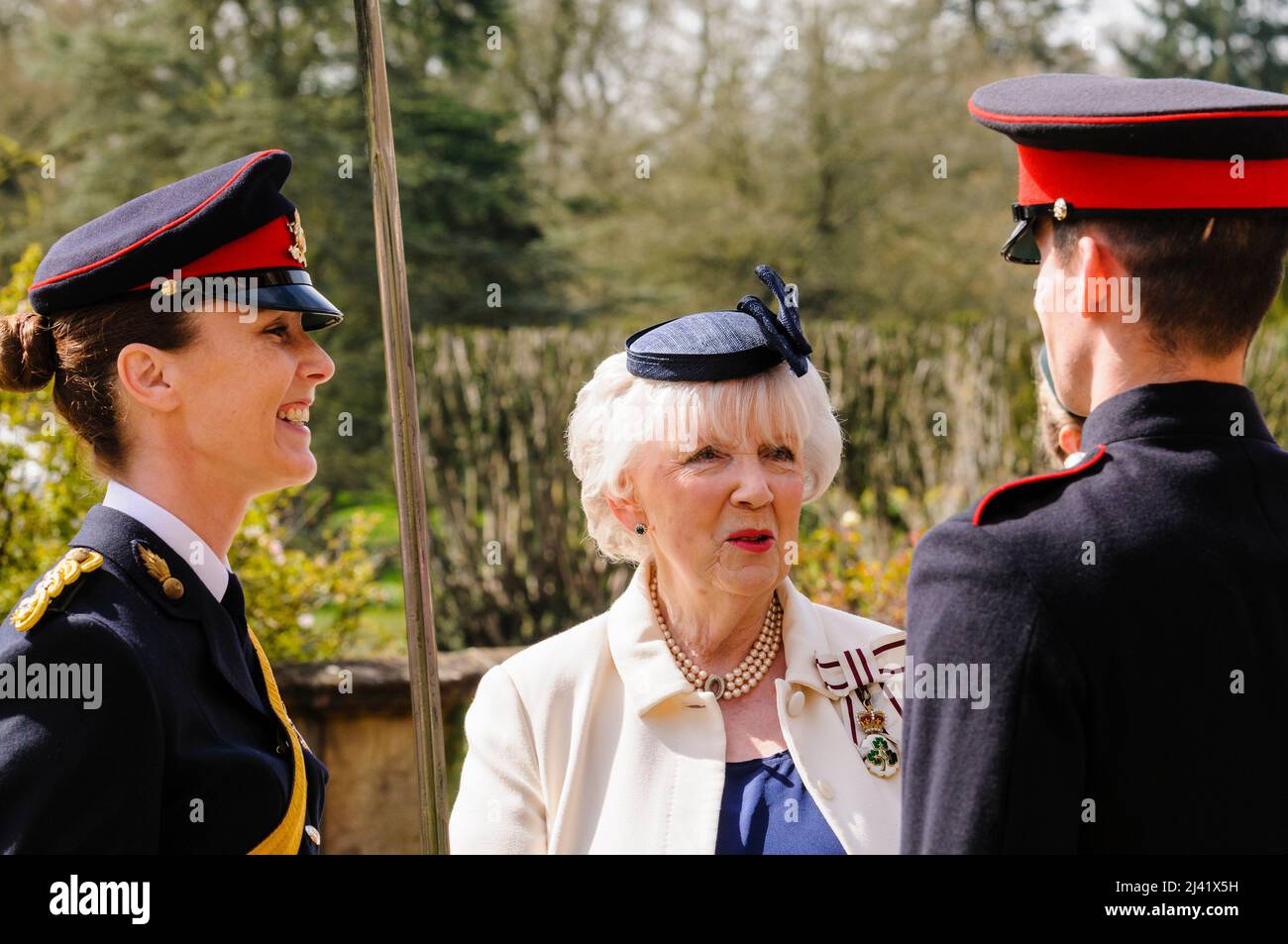 HILLSBOROUGH, NORTHERN IRELAND - APR 21 2016: Lord Lieutenant of County Antrim, Mrs. Joan Christie, congratulates members of Queens University Officer Training Corps who were given the honour of firing the special 21 Gun Salute to celebrate HM Queen Elizabeth's 90th birthday. Stock Photo