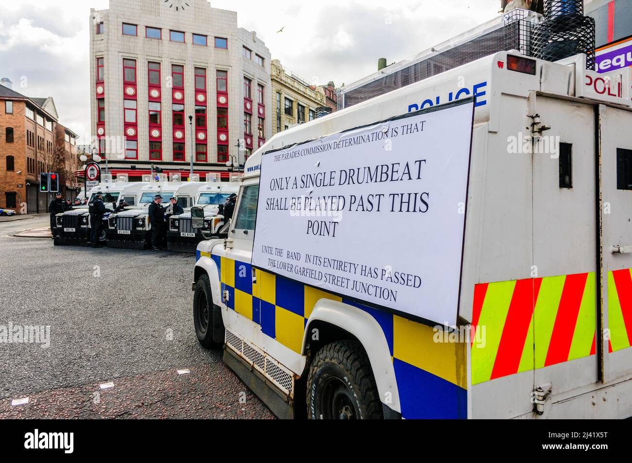 BELFAST, NORTHERN IRELAND: APR 24 2016 - A PSNI Landrover carries a message stating that only a single drumbeat may be played by the band as a Republican Parade is about to pass through Belfast City Centre to commemorate the 100th anniversary of the Irish Easter Rising. Stock Photo