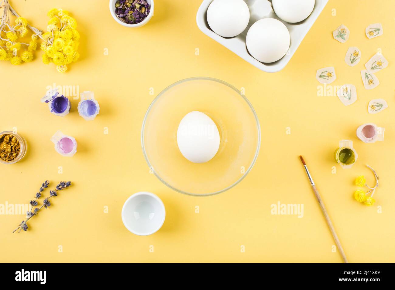 Easter decorated eggs on yellow background. Minimal happy easter concept. Top view. Stock Photo