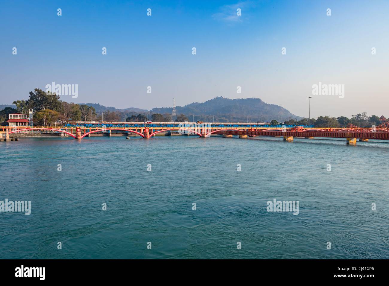 isolated iron bridge over ganges river with colorful sky at evening image is taken at haridwar uttrakhand india. Stock Photo