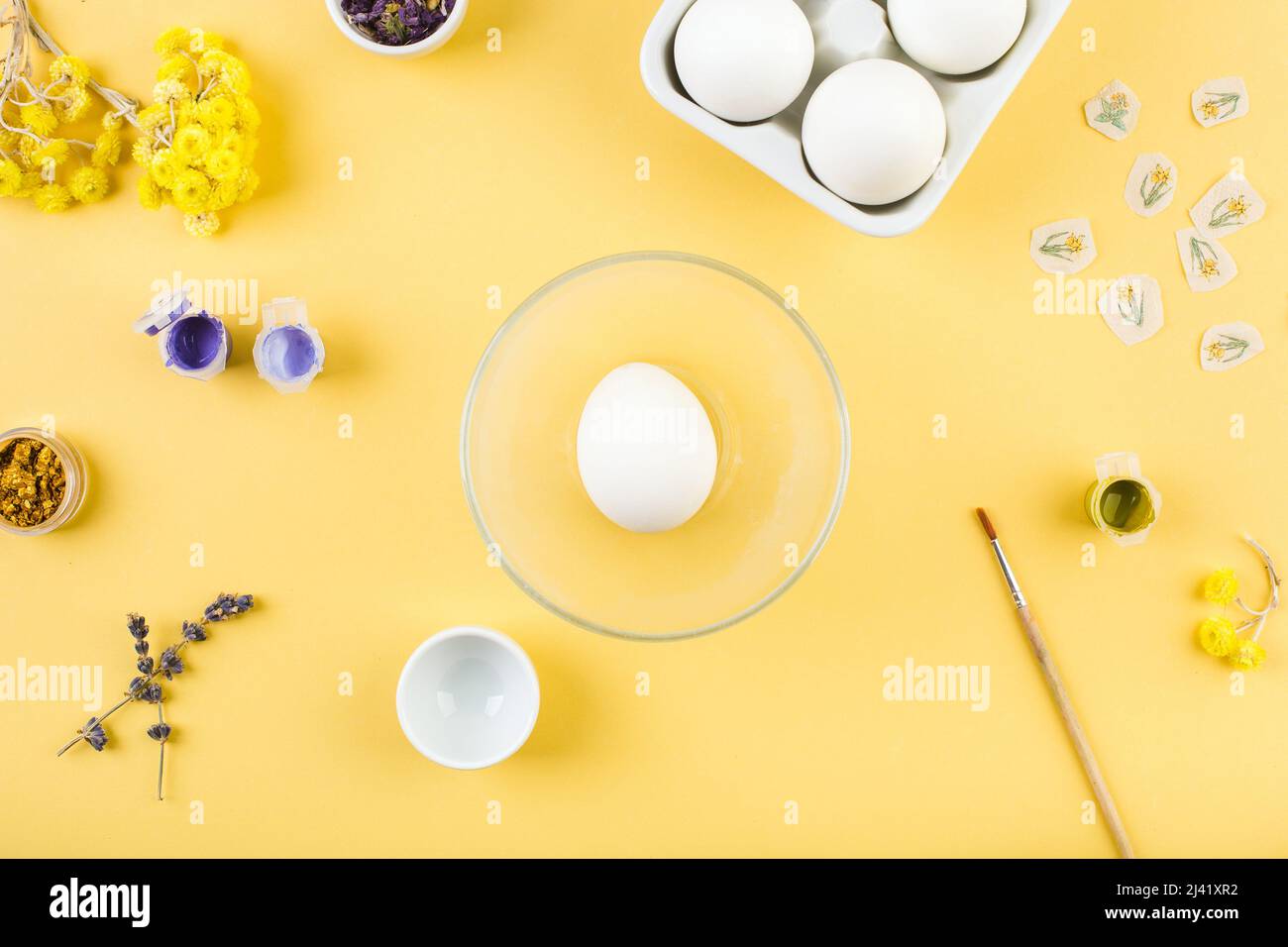 Easter decorated eggs on yellow background. Minimal happy easter concept. Top view. Stock Photo