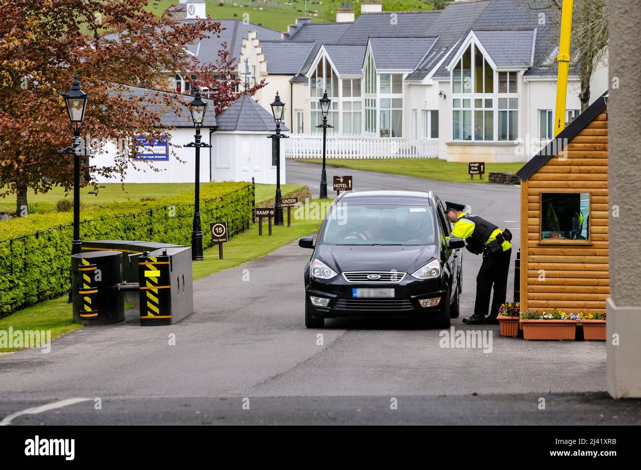 26/05/2013, Enniskillen, County Fermanagh, Northern Ireland.  A PSNI officer questions a departing driver as security is significantly increased at the entrance of the Lough Erne Golf Resort ahead of the G8 Summit, due to be held on the 17th and 18th June 2013. Stock Photo