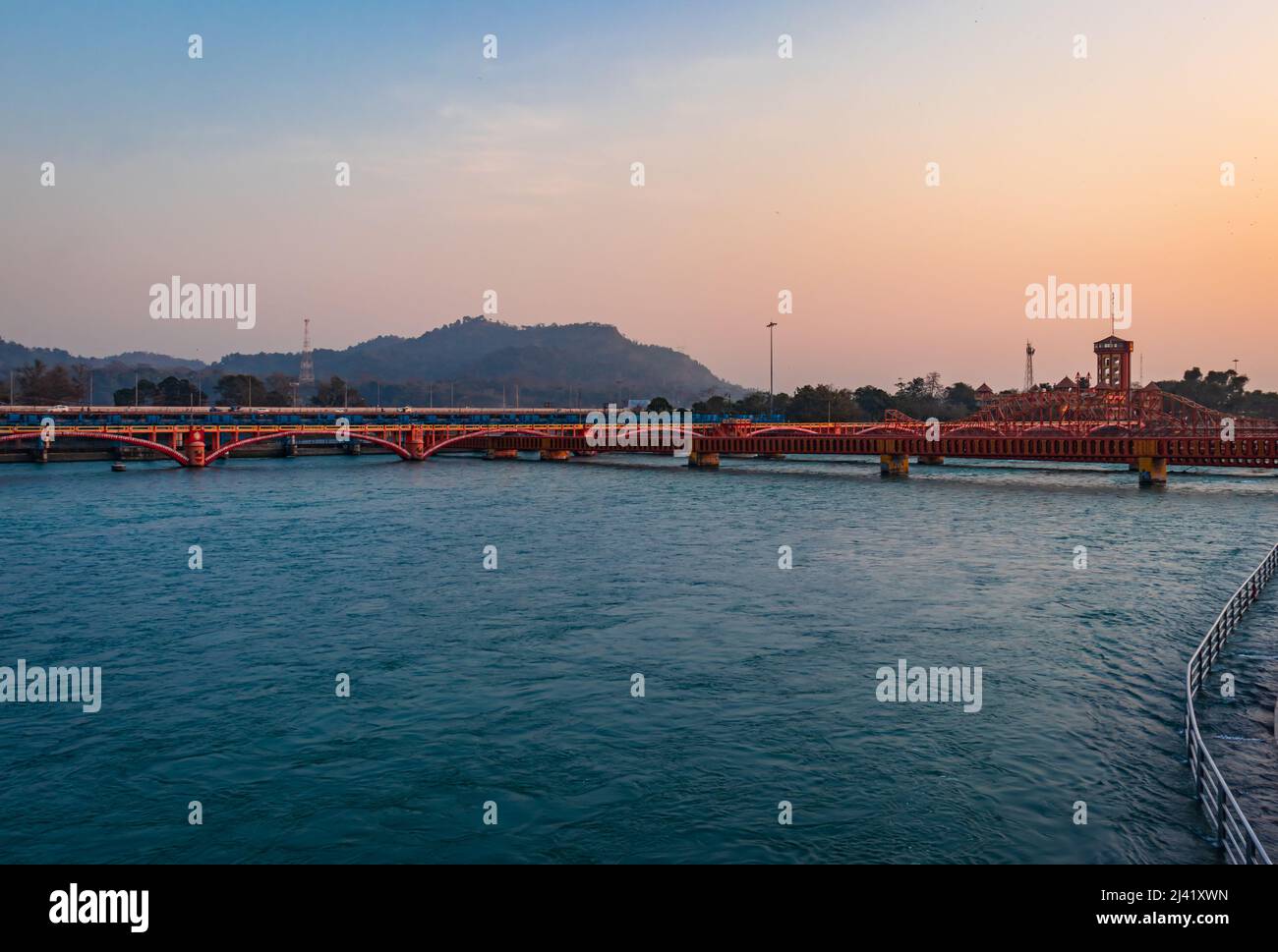 isolated iron bridge over ganges river with colorful sky at evening image is taken at haridwar uttrakhand india. Stock Photo