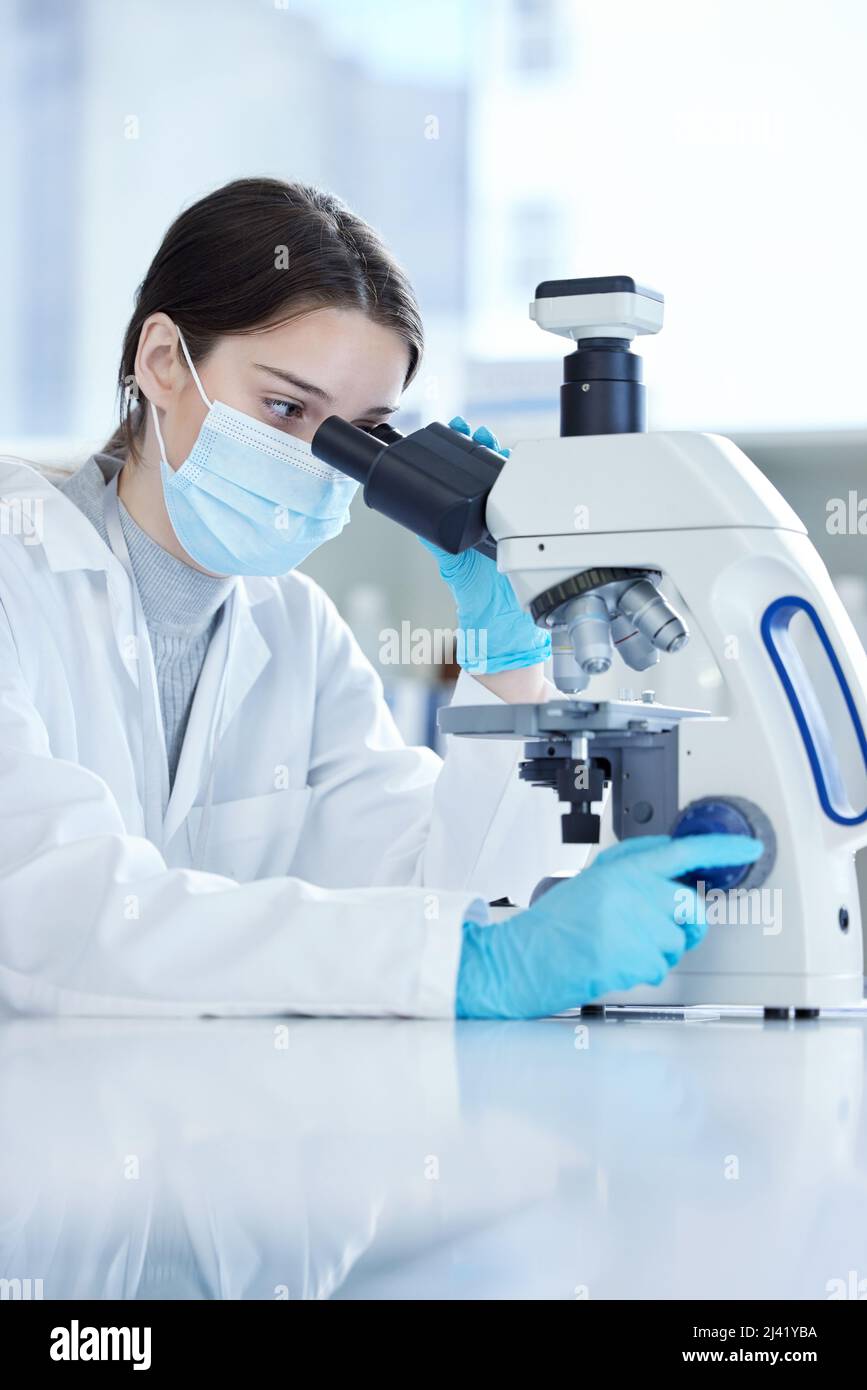 Laboratory worker using modern microscope in mask and gloves hi-res ...
