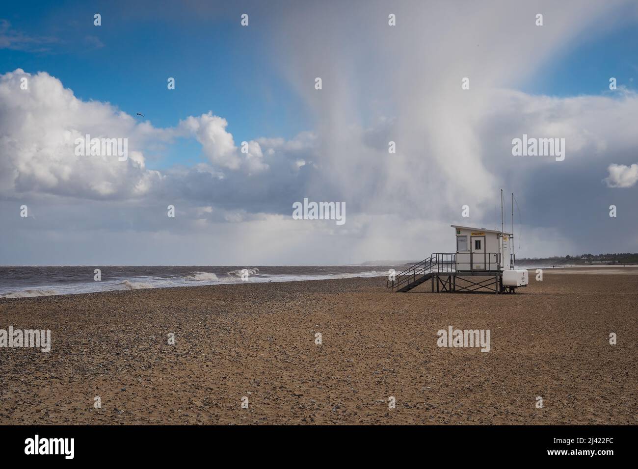 Hail storm above lifeguard hut on cold empty beach, Gorleston-on-Sea, Norfolk Stock Photo