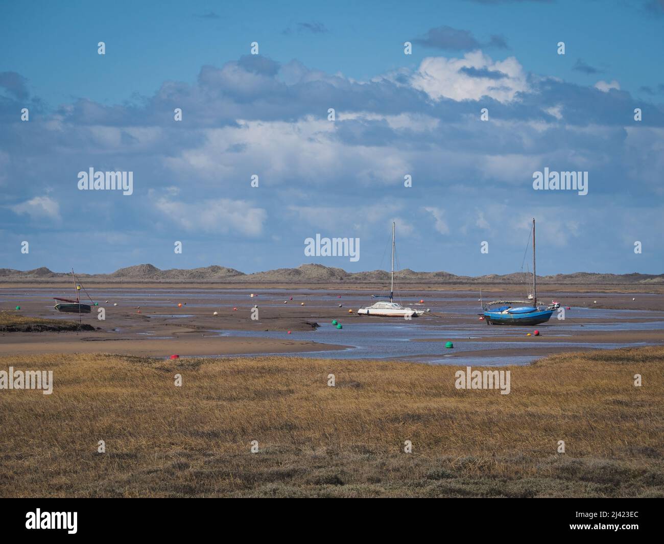 Boats aground on the salt marshes, Blakeney National Nature Reserve, Norfolk Stock Photo