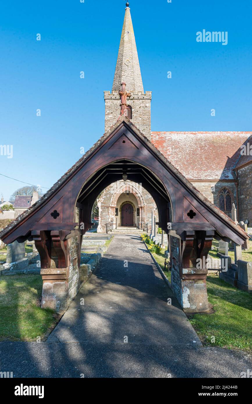 Wooden arch over the path leading to a church door. Stock Photo