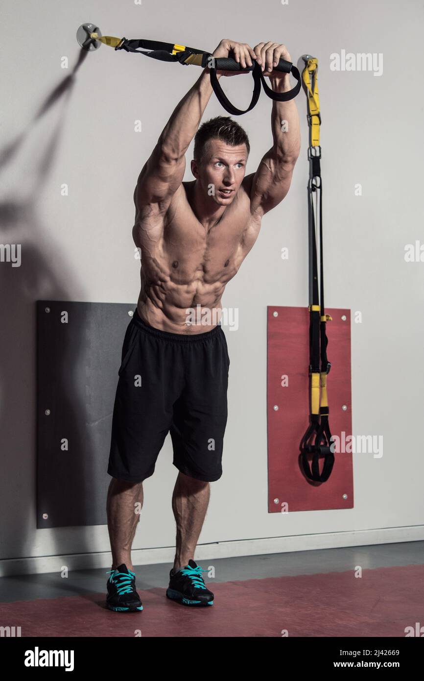 Muscular man during workout in the gym Stock Photo