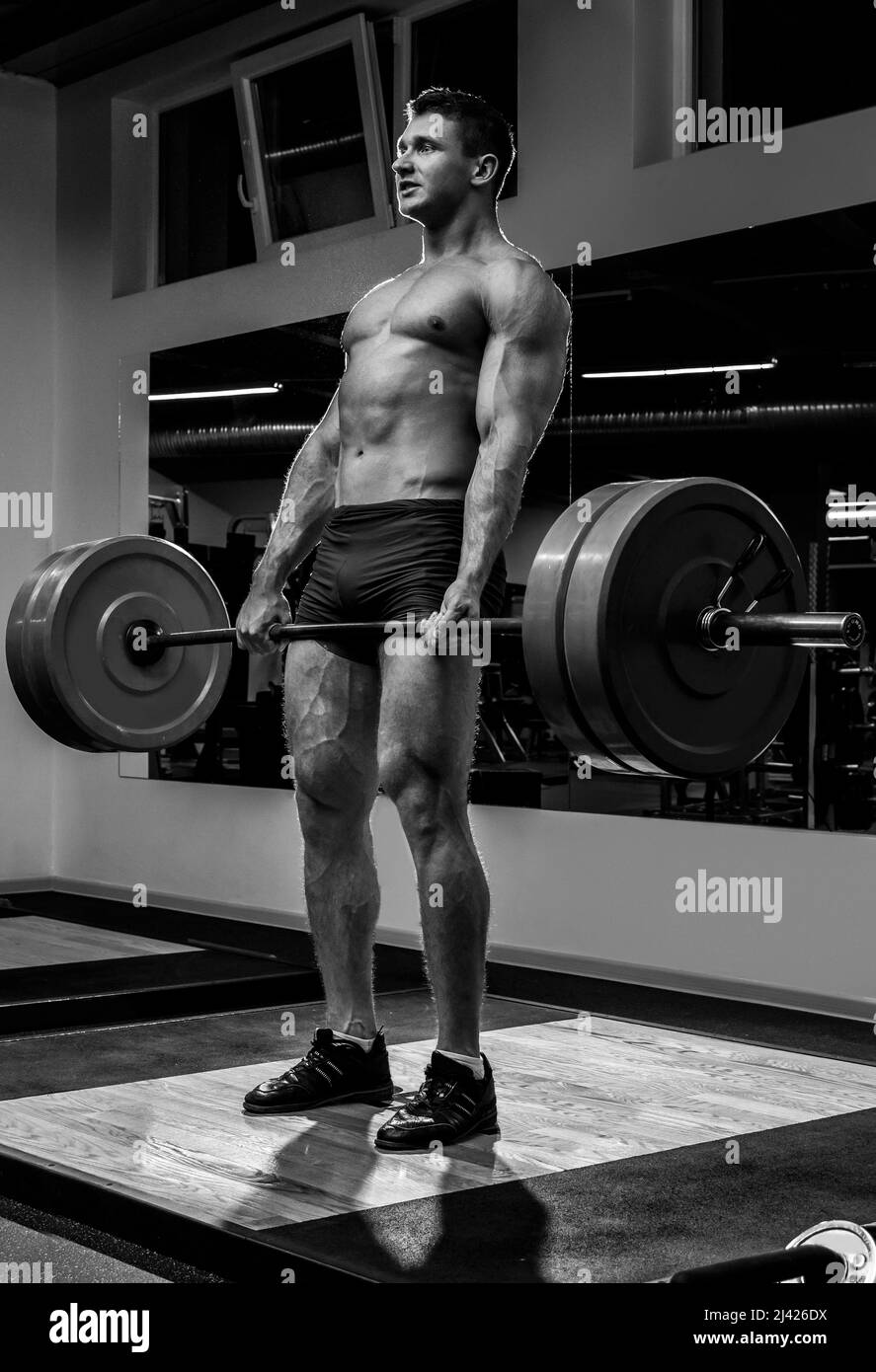 Strong man doing deadlift exercise in the gym Stock Photo