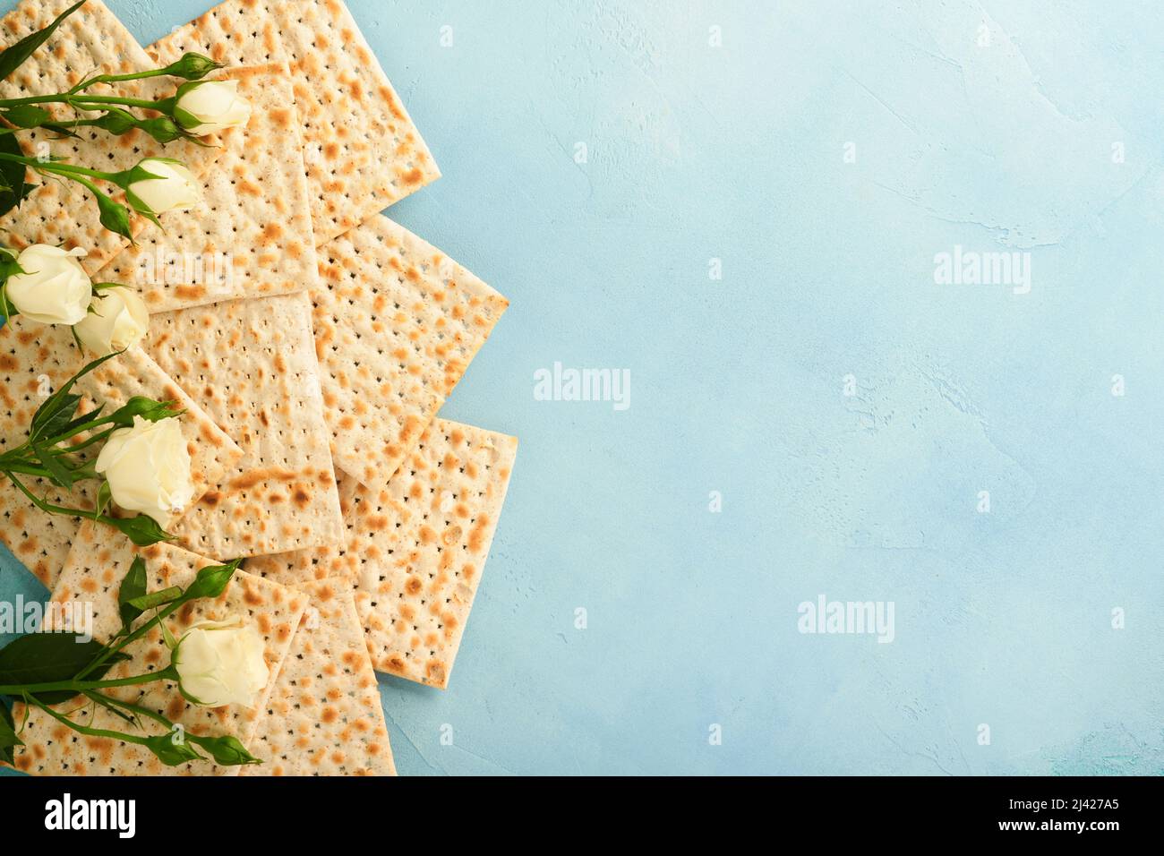 Passover celebration concept. Matzah, red kosher walnut and spring