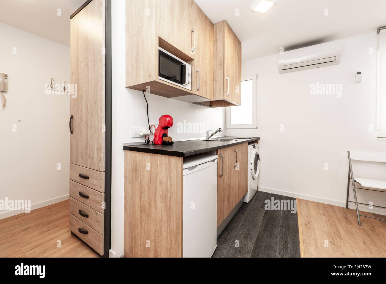 Kitchen with wood with black countertops and white appliances