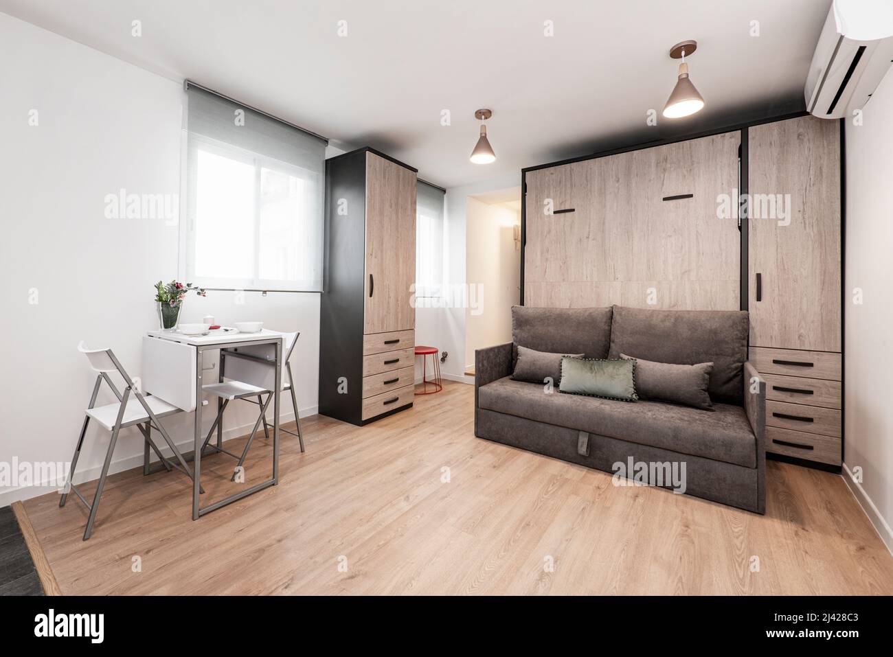 Studio apartment living room white folding dining table and matching